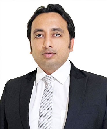 Portrait of Mr. Digant Sharma in a dark suit, white shirt and patterned tie